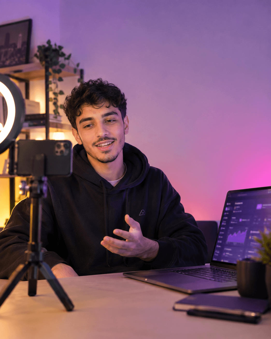 Content creator filming a video for a brand, with the Kolab dashboard open on their laptop